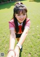 A young woman in a school uniform taking a selfie.