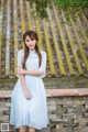 A woman in a blue dress posing for a picture.